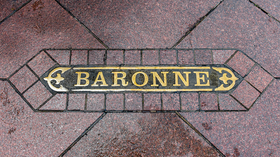 Baronne Street sign at sidewalk of downtown district, New Orleans.
