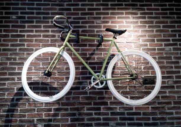 A bicycle hung at a bricked wall