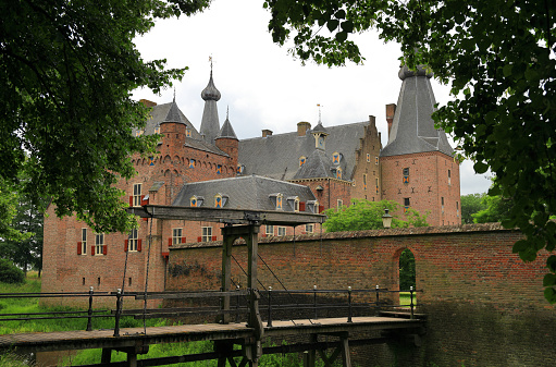 Doorwerth, the Netherlands - June 26, 2022: Visiting the Doorwerth Castle, a moated castle in the floodplains of the Rhine near the village of Doorwerth, in the Dutch province of Gelderland.