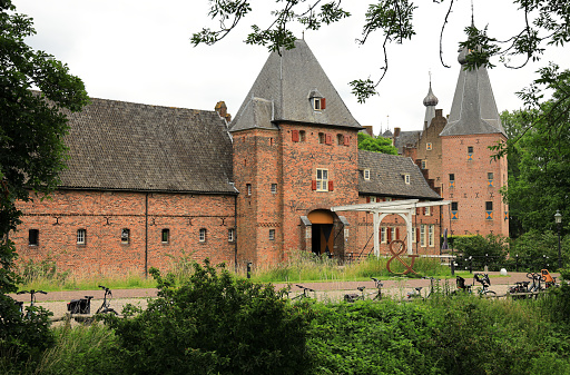 Doorwerth, the Netherlands - June 26, 2022: Visiting the Doorwerth Castle, a moated castle in the floodplains of the Rhine near the village of Doorwerth, in the Dutch province of Gelderland.