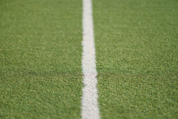 green artificial grass soccer sports field with white stripe - soccer soccer field grass artificial turf imagens e fotografias de stock