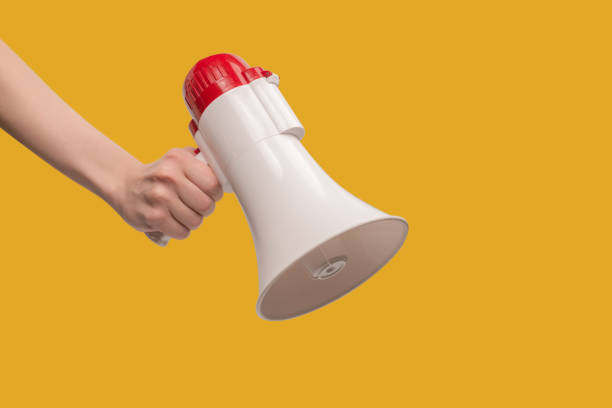 istock Megaphone in woman hands on a white background. 1406780196