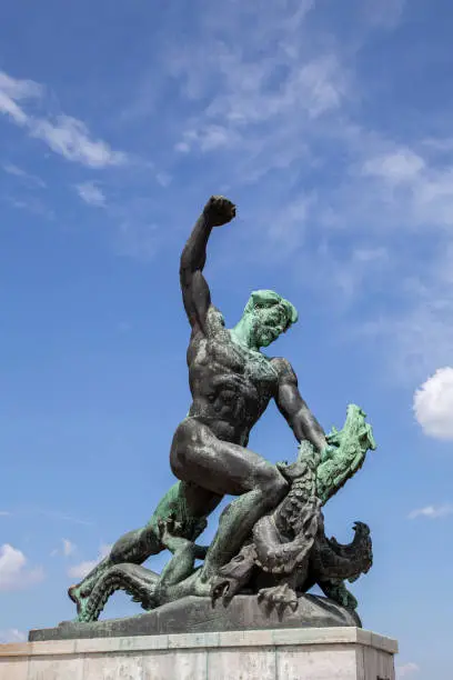 One of three statue, Statue of Liberty on Gellert Hill in Budapest, Hungary 	A bronze sculpture depicting a hero fighting a mythical beast, at the base of the Communist-era Freedom Monument in Budapest, Hungary