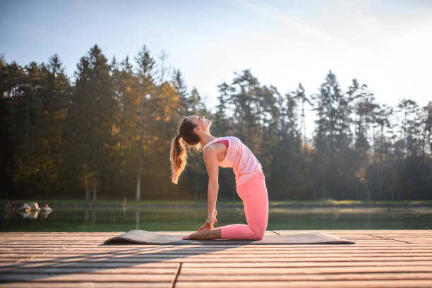 istock Young White Female Doing Yoga, Balancing On Her Knees 1406782981