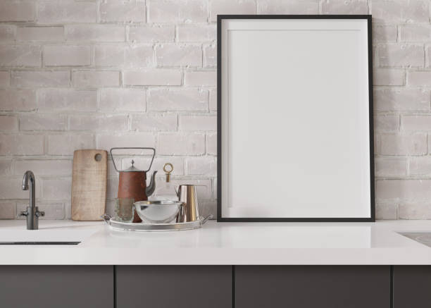istock Empty vertical picture frame standing in modern kitchen. Mock up interior in minimalist, contemporary style. Free, copy space for your picture, poster. Close up view. 3D rendering. 1406783551