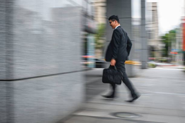 istock Young Japanese Business Intern Rushing To Work 1406783670