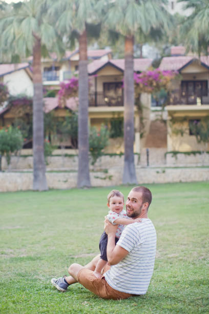 istock Father and baby walking in park 1406785508