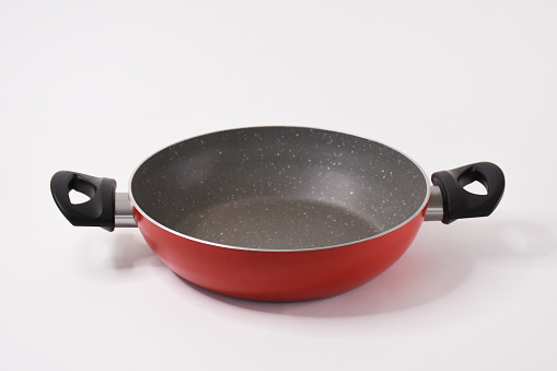 Empty clean frying pan on the white background