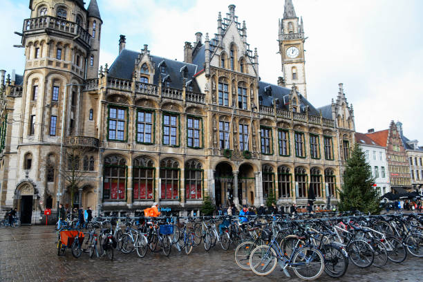 Ghent, Belgium - December 28, 2021: Korenmarkt square in Ghent with parked bicycles in the foreground.