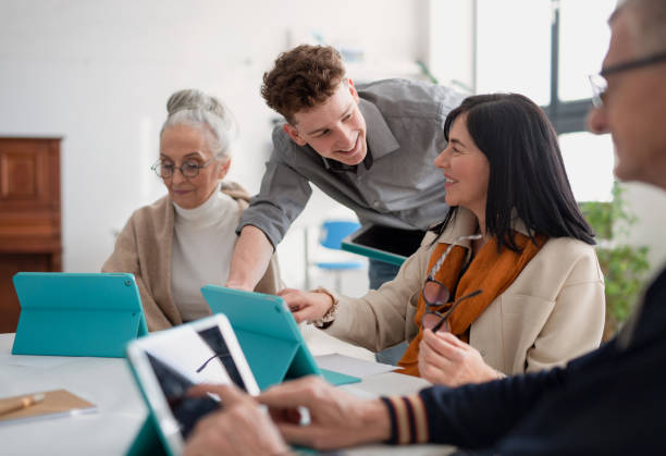 istock Group of seniors attending IT class in community centre with teacher 1406787299