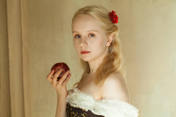Smiling playful young blonde woman contemplating a situation off camera..