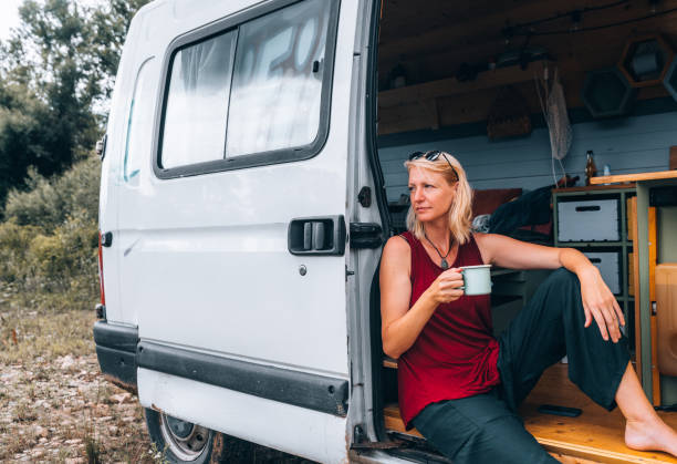 istock Woman enjoys coffee from her van 1406788239