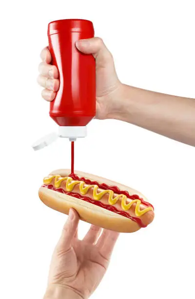 Photo of Delicious hot dog cooking on white