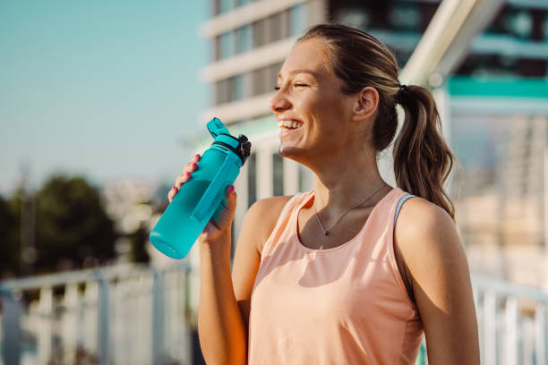 istock Young woman refreshing herself after her sports training 1406790906