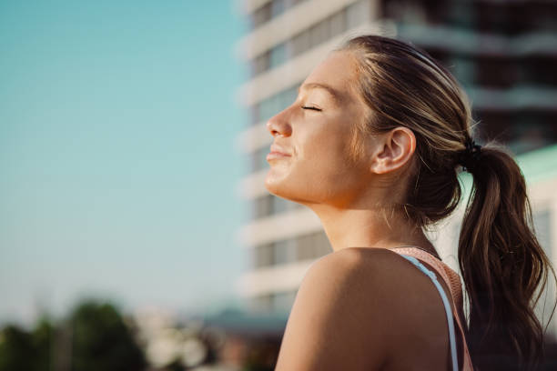 istock Blond woman enjoying the sun 1406790973