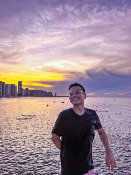 istock Handsome man enjoying the sunset near a beach. 1406791147