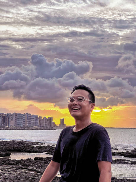 istock Handsome man enjoying the sunset near a beach. 1406791157