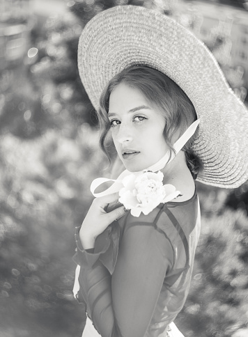 Black and white portrait of a girl in a straw hat.