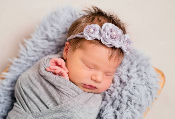 istock Cute little baby with knitted toy bunny lying 1406792781