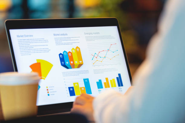istock Close up of businessman using a laptop with graphs and charts on a laptop computer. 1406793906
