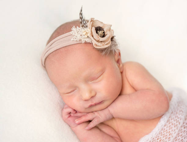 istock Cute sleeping newborn girl on white plaid 1406793981