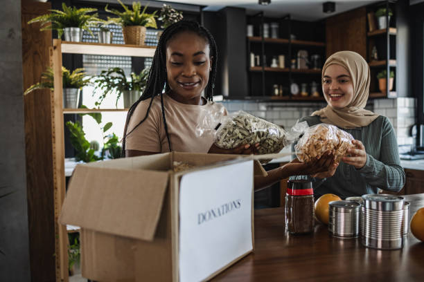 istock Two female social workers preparing nonperishable food in a donation boxes 1406795223