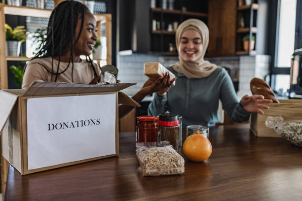 istock Two young woman preparing food for donation 1406795271