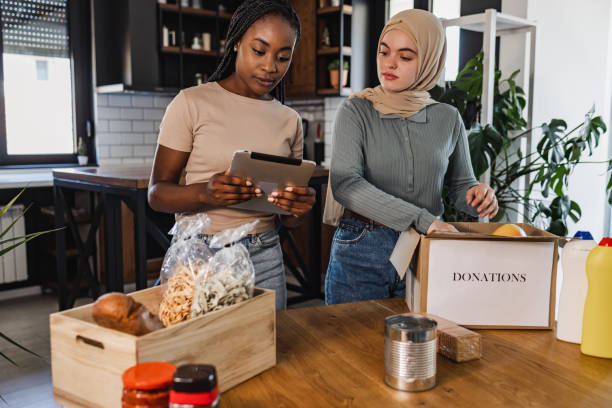 istock Two young woman looking at the list while preparing food for donation 1406796501