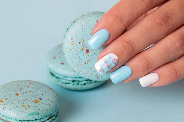 istock Female hand with blue manicure nails 1406796722