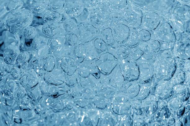 istock Close up of clear water bubbles in light blue color. 1406802763