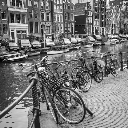 Amsterdam, Netherlands - September 9, 2011: Bicycles by canal railing in Amsterdam