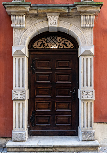 Gdansk, Poland - January 23, 2022: Antique carved wooden door. Entrance to a luxurious mansion in the historic quarter of Gdansk. Traditional old european city architecture