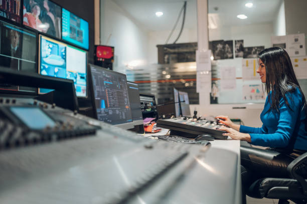 istock Middle aged woman using equipment in control room on a tv station 1406805968