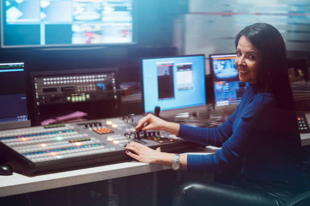 istock Middle aged woman using equipment in control room on a tv station 1406805972