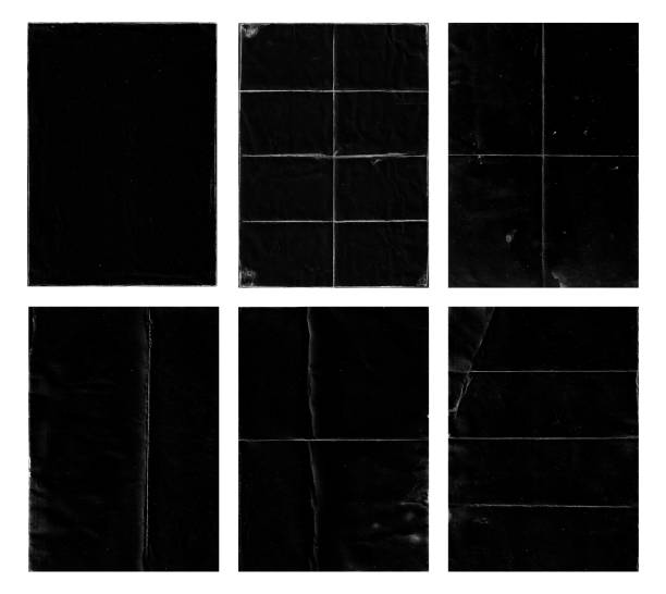 Set of folded paper with grungy texture in black background.