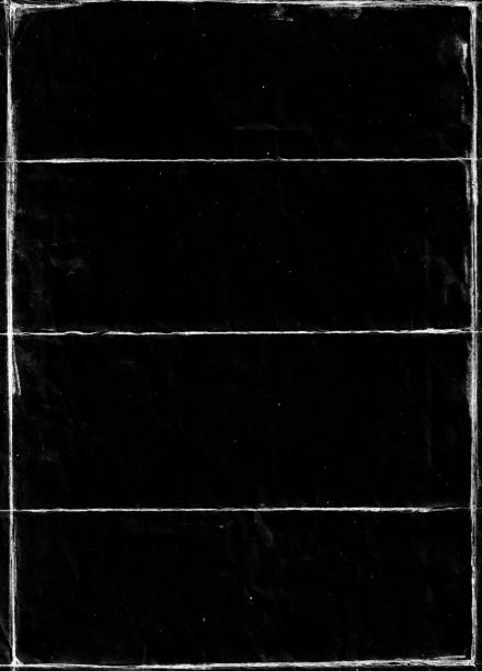 istock Folded paper with grungy texture in black background. 1406807399