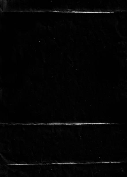 istock Folded paper with grungy texture in black background. 1406807413