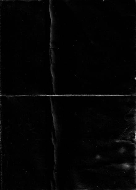istock Folded paper with grungy texture in black background. 1406807417