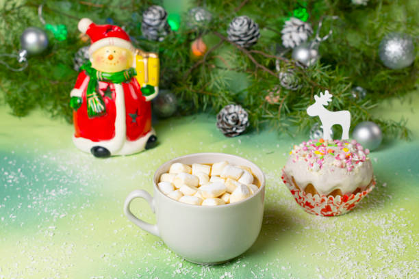 istock Hot chocolate with marshmallows, festive muffin on table with Christmas decor 1406808358