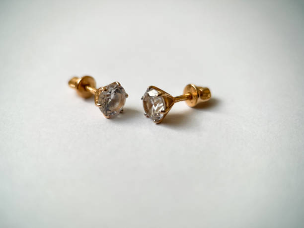 istock Gold stud earrings with cubic zirconia close-up 1406819725