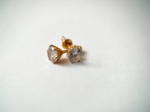 istock Gold stud earrings with cubic zirconia close-up 1406819733
