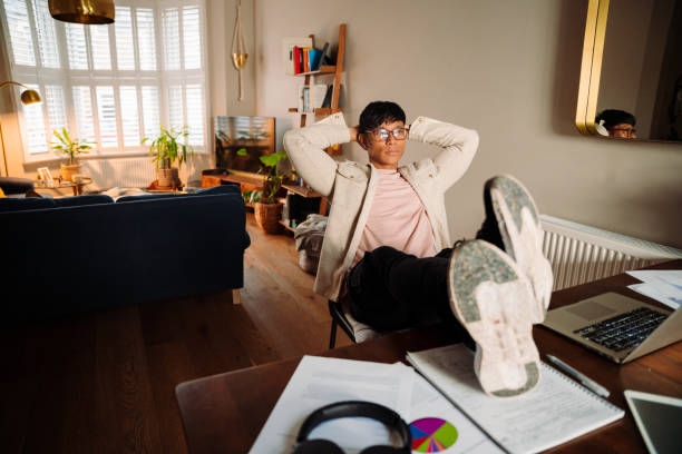istock Asian male very relaxed at work station 1406820030