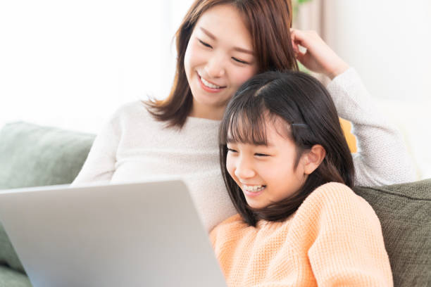 istock parent and daughter,laptop computer, 1406823000