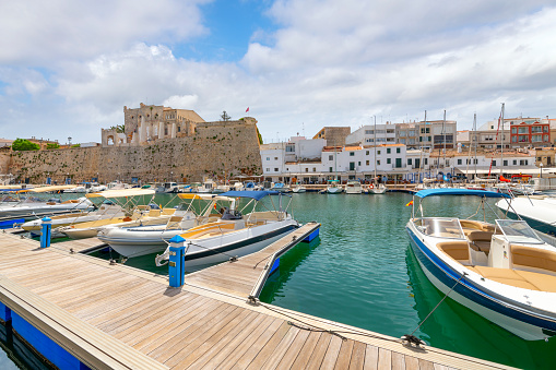 Fishing boats, sailboats and yachts in a Mediterranean marina at the picturesque Port of Ciutadella in Ciutadella de Menorca, on the Balearic island of Minorca or Menorca Spain.
