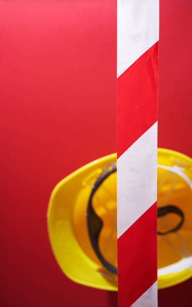barricade  tape and construction  helmet