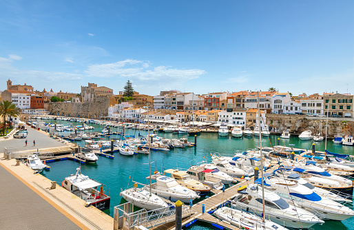 Fishing boats, sailboats and yachts at the colorful historic old port at Ciutadella de Menorca, Spain, on the Balearic island of Menorca in the Mediterranean Sea.