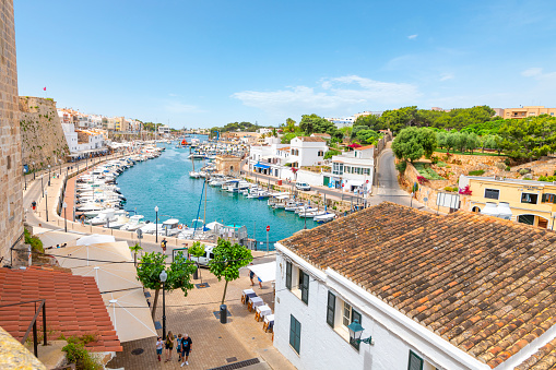 Fishing boats, sailboats and yachts at the colorful historic old port at Ciutadella de Menorca, Spain, on the Balearic island of Menorca in the Mediterranean Sea.