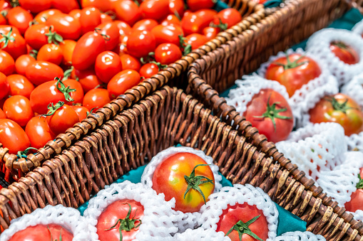 Tomatoes in baskets in supermarket