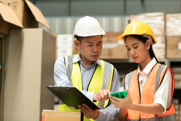 istock Warehouse Manager with female assistant Rethink a plan to prepare items that need to be sold to retailers during times of higher market prices. 1406830212
