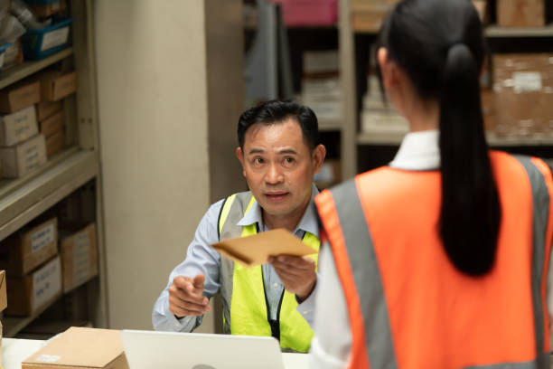 istock The warehouse manager gave the female assistant a premium. who assisted in the work and planning of the preparation of products to be sold to the retailers until it was very successful 1406830238